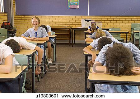 Stock Image - Tired kids in class. Fotosearch