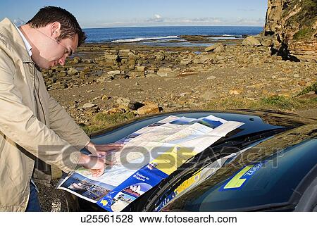 Stock Photo - Tourist looking at map. Fotosearch