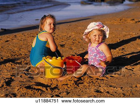 Stock Image - Two kids on the beach. Fotosearch