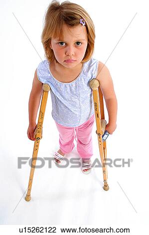Stock Image - Unhappy girl on crutches. Fotosearch