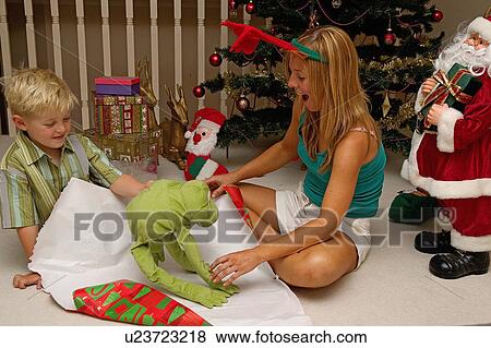 Unwrapping a gift View Large Photo Image Stock Photo - Unwrapping a gift. Fotosearch