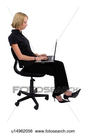 Using a laptop in office chair View Large Photo Image Stock Photograph - Using a laptop in office chair. Fotosearch