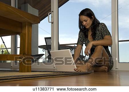 Using laptop at home View Large Photo Image Stock Image - Using laptop at home. Fotosearch