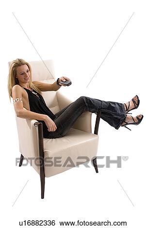 Stock Photograph - Watching TV in chair. Fotosearch