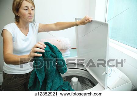 Stock Image - Woman at the washing machine. Fotosearch
