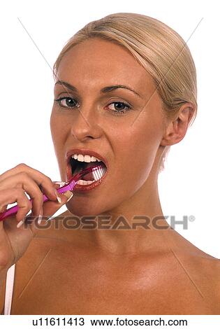 Stock Image - Woman brushing her teeth. Fotosearch