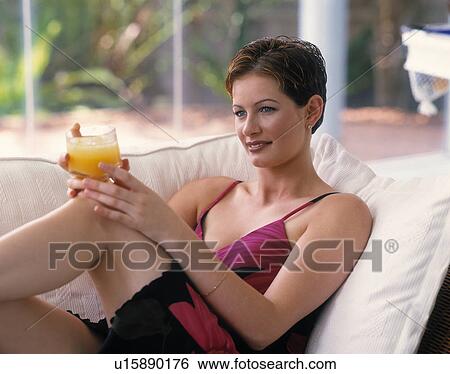 Woman drinking orange juice View Large Photo Image Stock Photograph - Woman drinking orange juice. Fotosearch