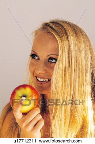 Woman eating an apple View Large Photo Image Stock Image - Woman eating an apple. Fotosearch