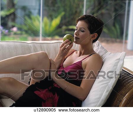 Woman eating an apple View Large Photo Image Stock Photography - Woman eating an apple. Fotosearch