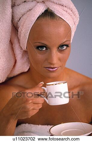 Stock Image - Woman having coffee after a shower. Fotosearch