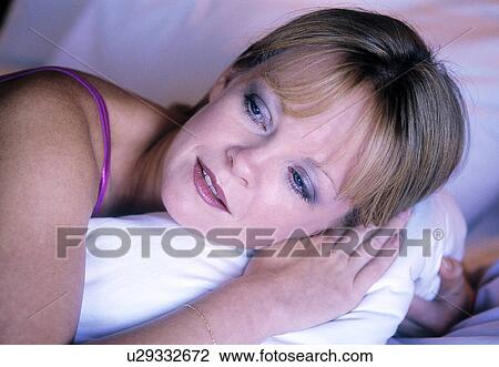 Woman in bed in the early morning View Large Photo Image Stock Image - Woman in bed in the early morning. Fotosearch