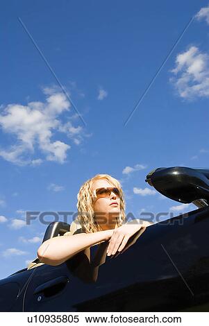 Stock Photography - Woman in convertible sports car. Fotosearch