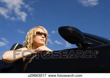 Woman in convertible View Large Photo Image Stock Photo - Woman in convertible. Fotosearch