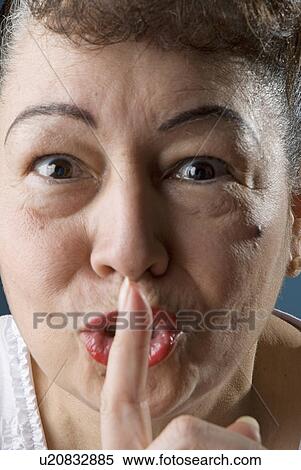 Stock Photography - Woman making the quiet sign. Fotosearch