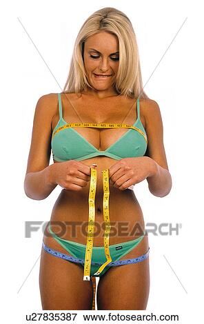 Stock Photo - Woman measuring herself. Fotosearch