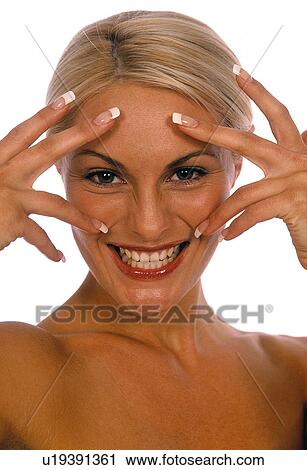 Stock Image - Woman smiling with hands on her face. Fotosearch