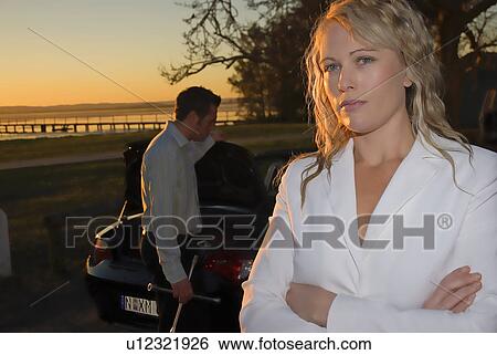Stock Photograph - Woman unhappy with car breakdown. Fotosearch