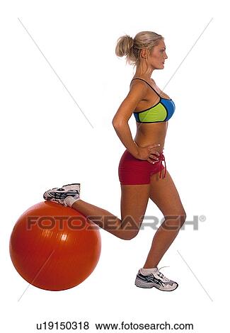 Stock Photo - Woman using an exercise ball. Fotosearch