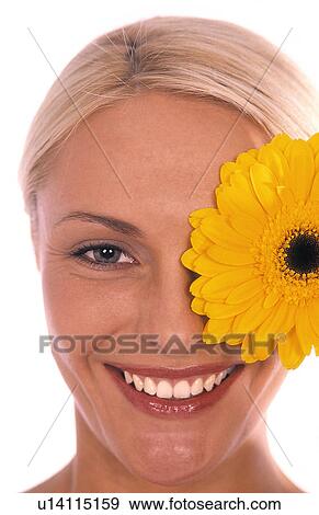 Stock Photo - Woman with a flower over her eye. Fotosearch