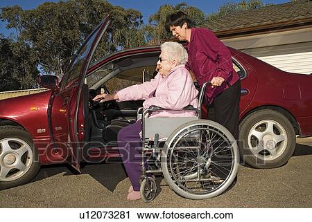 Women wheelchair and a car View Large Photo Image Stock Image - Women wheelchair and a car. Fotosearch