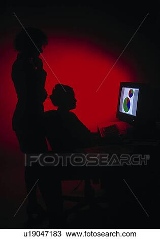 Stock Image - Women working at a computer. Fotosearch