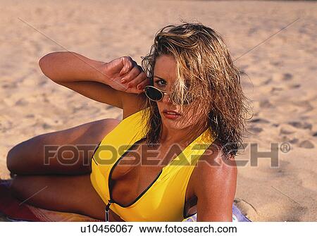 Stock Photo - Yellow bikini on the beach. Fotosearch