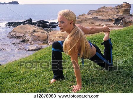 Stock Image - Yoga on the beach. Fotosearch