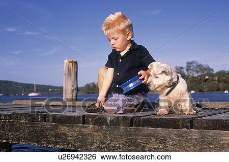 Young boy and his dog fishing View Large Photo Image Stock Photograph - Young boy and his dog fishing. Fotosearch