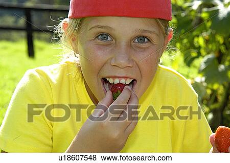 Young girl eating strawberries View Large Photo Image Stock Photo - Young girl eating strawberries. Fotosearch