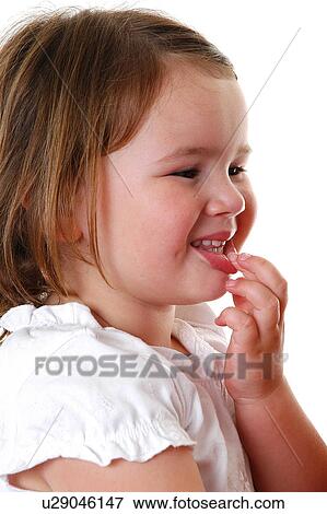 Stock Photo - Young girl holding lip. Fotosearch