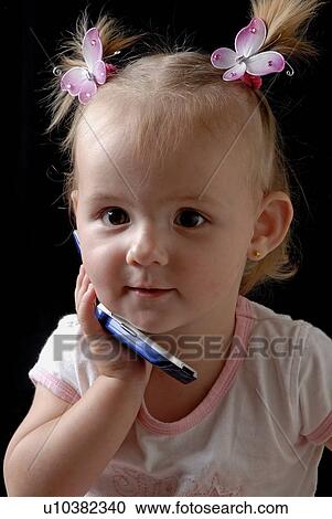 Young girl playing on the phone View Large Photo Image Stock Image - Young girl playing on the phone. Fotosearch