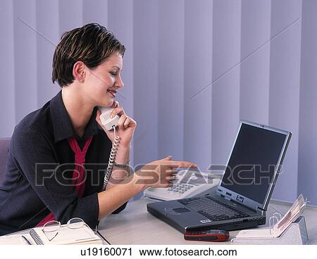 Young professional working at desk View Large Photo Image Stock Image - Young professional working at desk. Fotosearch