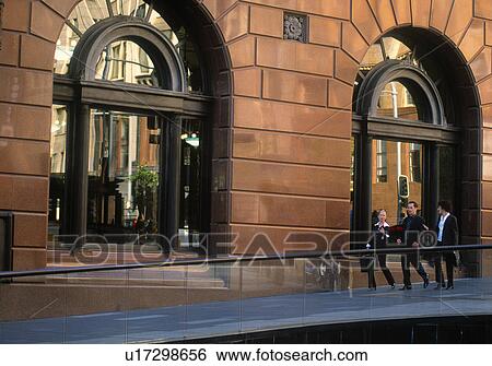 Young professionals walking on sidewalk View Large Photo Image Stock Photograph - Young professionals walking on sidewalk. Fotosearch
