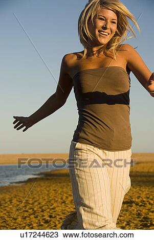 Young woman at beach View Large Photo Image Stock Image - Young woman at beach. Fotosearch