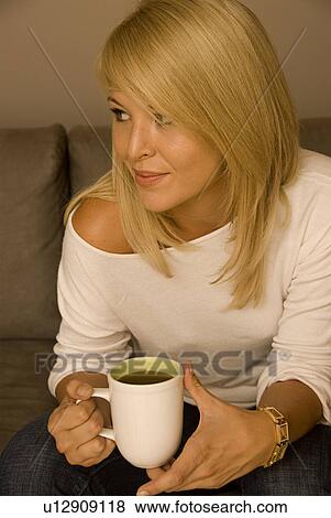 Young woman drinking coffee View Large Photo Image Stock Photo - Young woman drinking coffee. Fotosearch