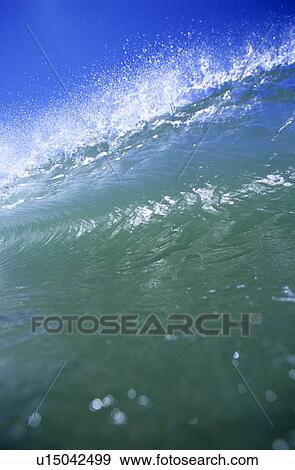 A close up shot of a wave breaking View Large Photo Image Stock Photo - A close up shot of a wave breaking. Fotosearch
