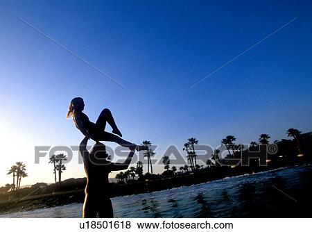 A couple tandem surfing in silhouette Ventura California USA View Large Photo Image Stock Photo - A couple tandem surfing in silhouette Ventura California USA. Fotosearch