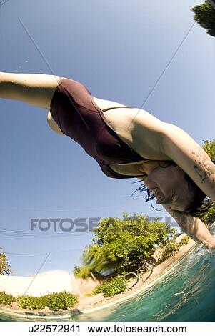 Stock Image - A female diving into a pool. Fotosearch