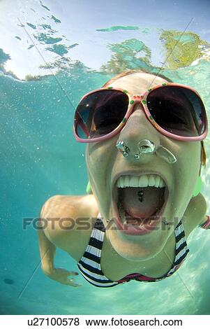 A female swimming under water View Large Photo Image Stock Photo - A female swimming under water. Fotosearch