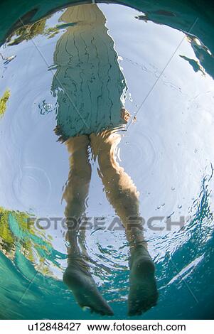 Stock Photo - A female's feet from under water. Fotosearch