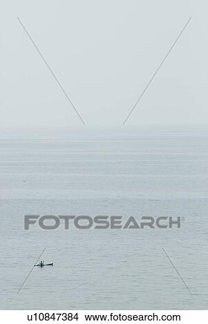 A Kayaker out in the middle of the ocean View Large Photo Image Picture - A Kayaker out in the middle of the ocean. Fotosearch