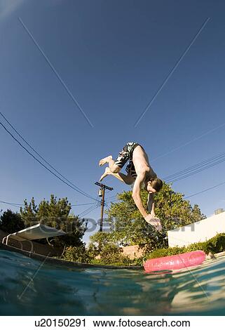Stock Image - A male diving into a pool. Fotosearch