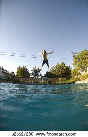 Stock Image - A male diving into a pool. Fotosearch