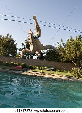 Stock Photo - A male diving into a pool. Fotosearch