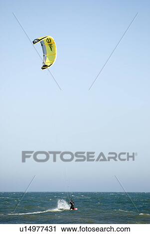 Stock Image - A male kite surfing. Fotosearch