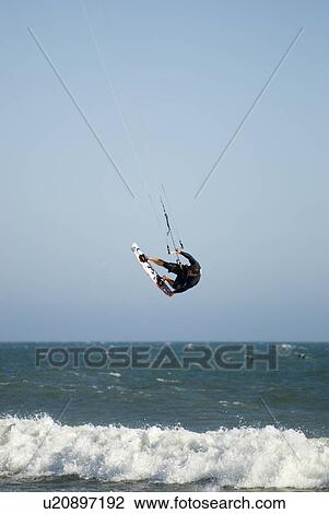 A male kite surfing View Large Photo Image Stock Image - A male kite surfing. Fotosearch