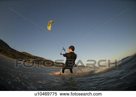 A male kite surfing View Large Photo Image Stock Photography - A male kite surfing. Fotosearch