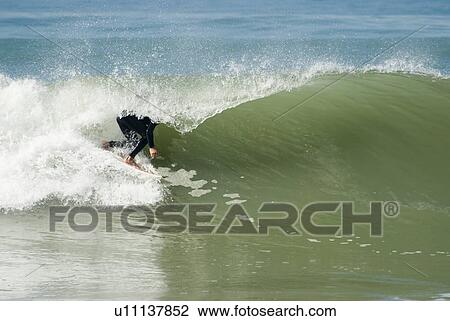 A male surfer in the wave View Large Photo Image Stock Image - A male surfer in the wave. Fotosearch
