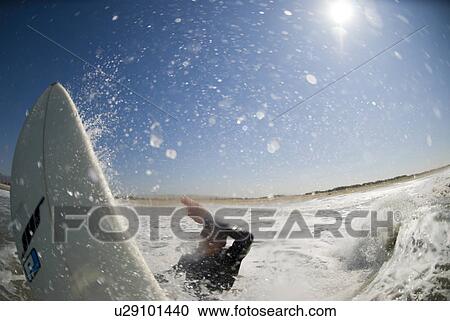 Stock Image - A male surfer. Fotosearch