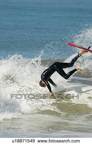 Stock Photo - A male surfer. Fotosearch